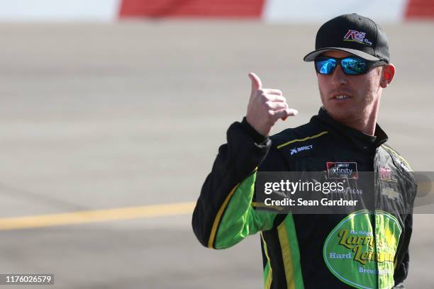 Ryan Sieg, driver of the Larry's Hard Lemonade Chevrolet, stands on the grid during qualifying for the NASCAR Xfinity Series GoBowling 250 at...