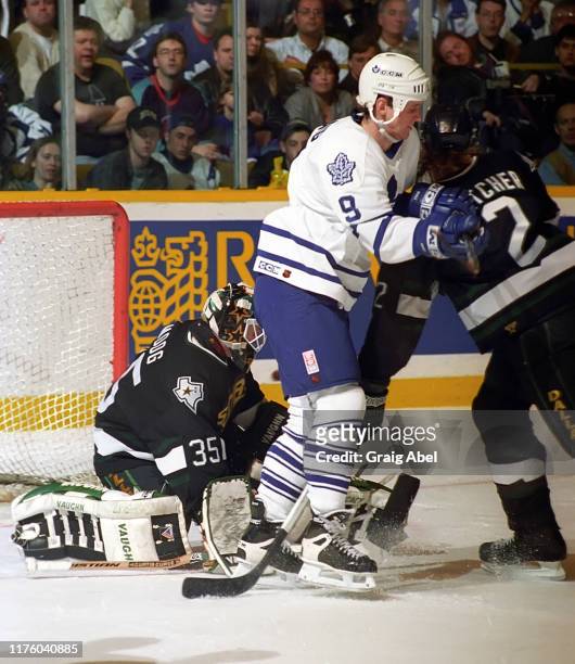 Mike Craig of the Toronto Maple Leafs skates against Andy Moog and Derian Hatcher of the Dallas Stars during NHL game action on March 15, 1996 at...