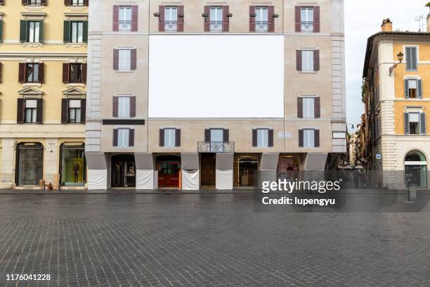 blank billboard on building facade - city poster stock-fotos und bilder