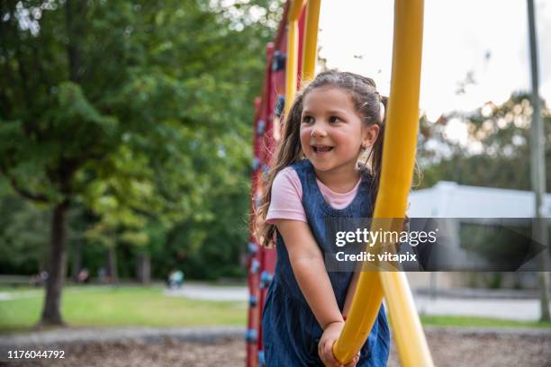 adorable girl playing at the school yard - schoolyard stock pictures, royalty-free photos & images