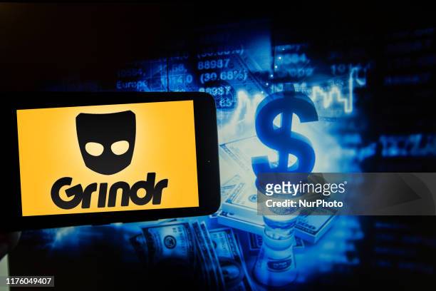 In this photo illustration taken in New York, US, on 15 October 2019 show the logo of the gay dating app Grindr is seen on a screen next to an...