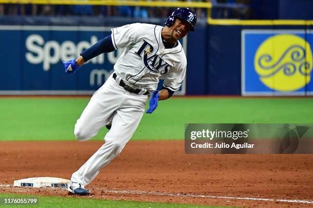 Johnny Davis of the Tampa Bay Rays rounds third after teammate Willy Adames hit an RBI single walk-off in the eleventh inning off of Trevor Kelley of...