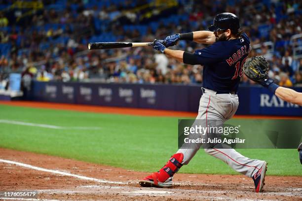Mitch Moreland of the Boston Red Sox hits a 2-run homer off of Emilio Pagan of the Tampa Bay Rays in the ninth inning of a baseball game at Tropicana...