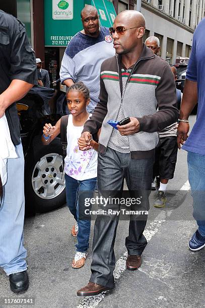 Professional boxer Floyd Mayweather Jr. And his daugher Iyanna Mayweather leave his Midtown Manhattan hotel on June 28, 2011 in New York City.