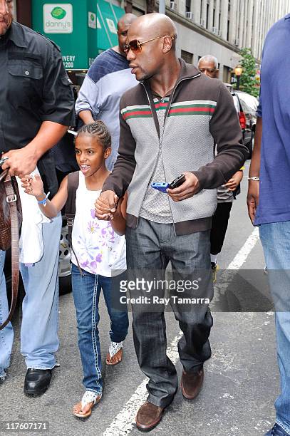 Professional boxer Floyd Mayweather Jr. And his daugher Iyanna Mayweather leave his Midtown Manhattan hotel on June 28, 2011 in New York City.