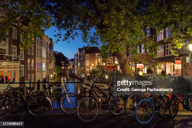bicycles in a canal of utrecht, the netherlands - utrecht stock-fotos und bilder