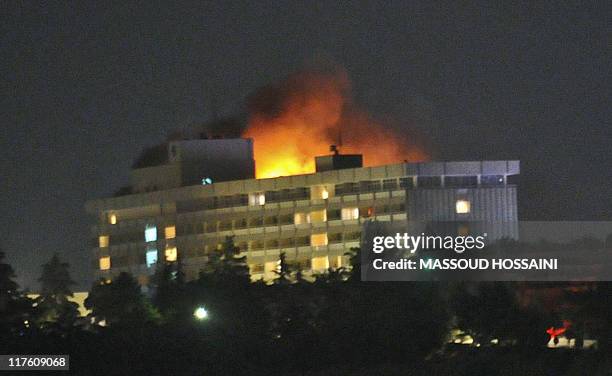 Smoke and flames light up the night from a blaze at the Intercontinental hotel after an attack on the hotel by Taliban fighters and a response by...