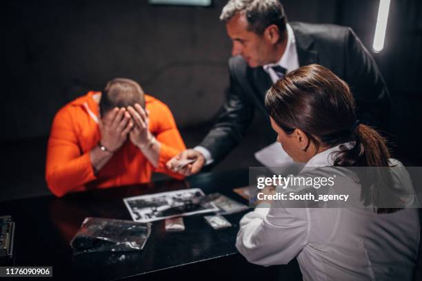 man with handcuffs and  detectives - confession law stock pictures, royalty-free photos & images