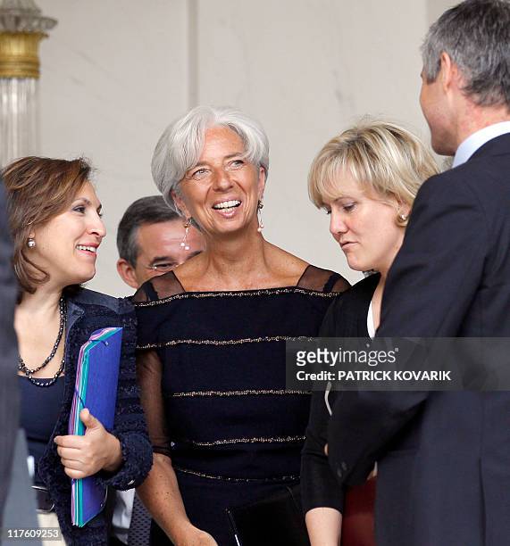 France's former Finance minister Christine Lagarde who was named the day before the first-ever female chief of the IMF, speaks with her colleagues...