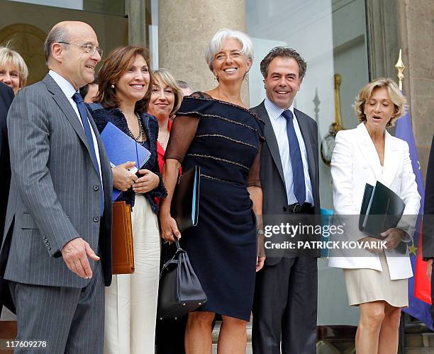 France's former Finance minister Christine Lagarde who was named the day before the first-ever female chief of the IMF, poses with her colleagues,...
