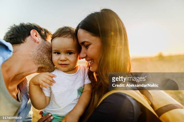 portrait of happy family outdoors - baby attitude stock pictures, royalty-free photos & images