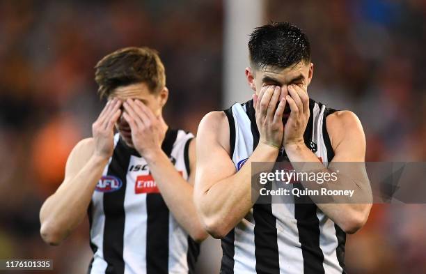 Josh Thomas and Brayden Maynard of the Magpies look dejected after losing the AFL Preliminary Final match between the Collingwood Magpies and the...