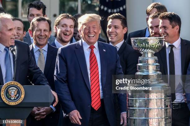 President Donald Trump smiles alongside the St. Louis Blues, the 2019 Stanley Cup Champions, in the Rose Garden of the White House in Washington,...