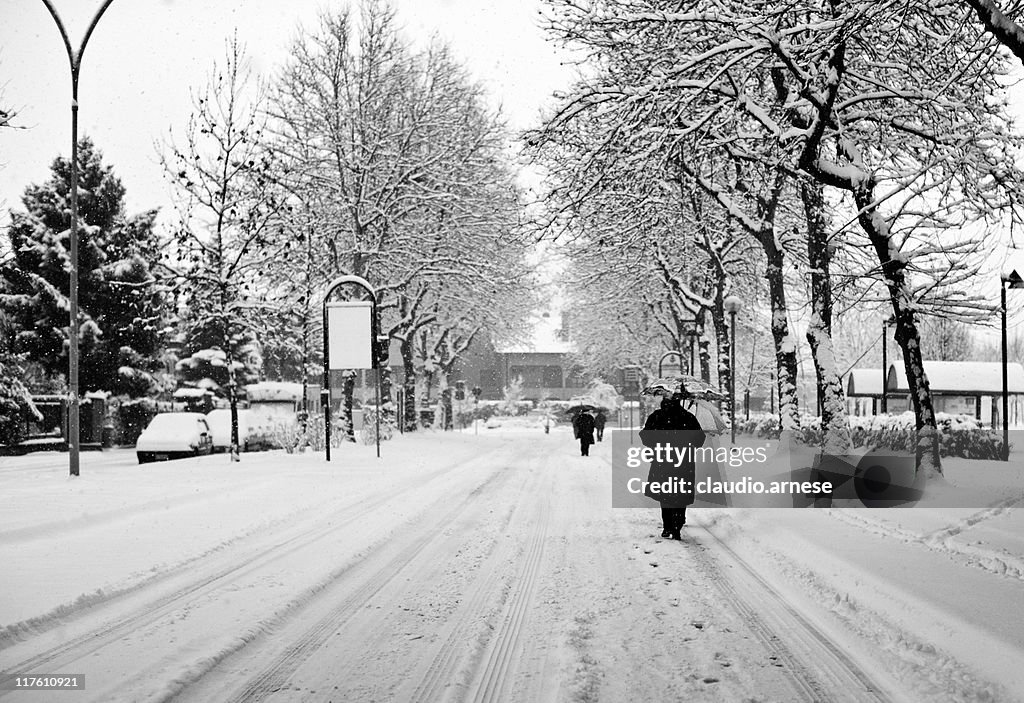 Snowy Street with People Walking. Black and White