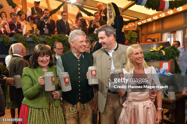 Bavarian Minister-President Markus Soeder and his wife Karin Soeder and Munich Mayor Dieter Reiter with his wife Petra Reiter during the opening of...