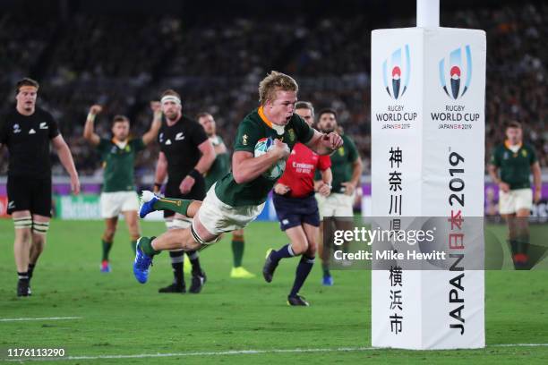 Pieter-Steph du Toit of South Africa dives to scores his side's first try during the Rugby World Cup 2019 Group B game between New Zealand and South...