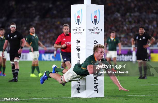 Pieter-Steph du Toit of South Africa dives to scores his side's first try during the Rugby World Cup 2019 Group B game between New Zealand and South...