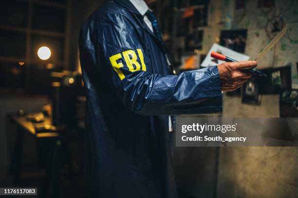 fbi agent working on a case late at night - fbi stock pictures, royalty-free photos & images