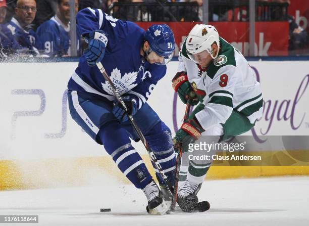 Mikko Koivu of the Minnesota Wild battles against John Tavares of the Toronto Maple Leafs during an NHL game at Scotiabank Arena on October 15, 2019...