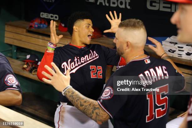 Juan Soto and Matt Adams of the Washington Nationals do a handshake in the dugout before Game 4 of the NLCS between the St. Louis Cardinals and the...