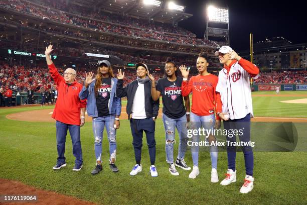 Coach Mike Thibault and members of the WNBA Champion Washington Mystics pose for a photo before Game 4 of the NLCS between the St. Louis Cardinals...