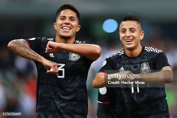 Roberto Alvarado of Mexico celebrates with teammate Carlos Salcedo of Mexico after scoring the first goal of his team during the match between Mexico...