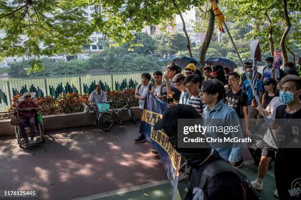 Pro-democracy protesters march through a park in Tuen Mun on September 21, 2019 in Hong Kong, China. Pro-democracy protesters have continued...