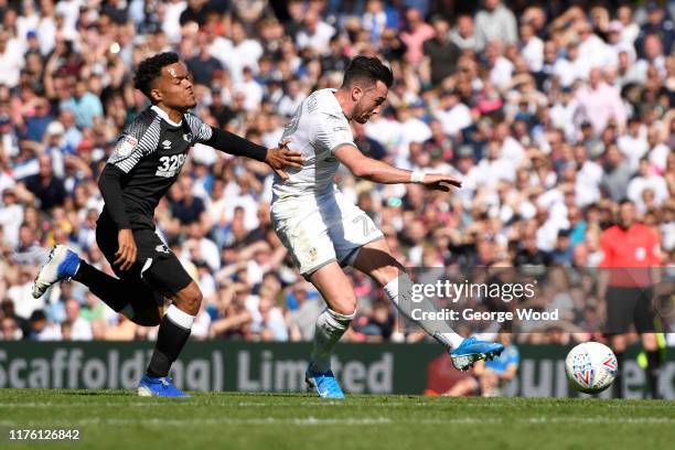 Jack Harrison of Leeds United shoots whilst being under pressure by Max Lowe of Derby County during the Sky Bet Championship match between Leeds...