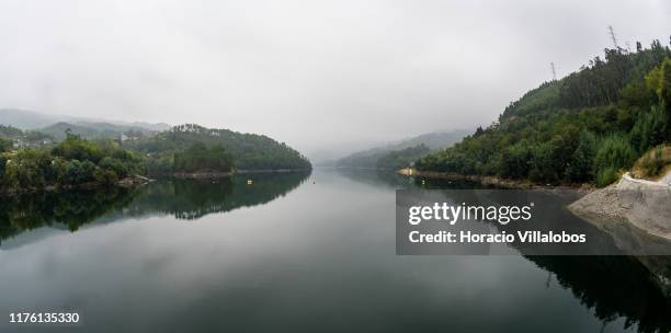 View of Cávado River on a foggy morning from Caniçada Dam, where site of Vhils large-scale mural conceived as a tribute to mankind's entrepreneurial...