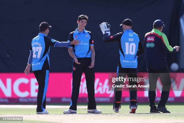 Bowler Pat Brown of Worcestershire Rapids is congratulated by teammates Daryl Mitchell and Ben Cox after dismissing Tom Moores of Notts Outlaws...