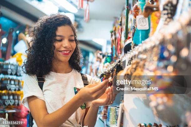 teenager girl buying in the craft fair - craft market stock pictures, royalty-free photos & images