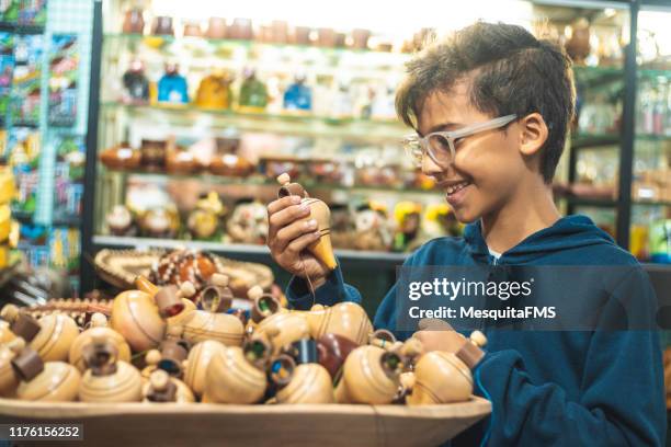 ragazzo che sceglie i giocattoli al negozio per bambini - trottola foto e immagini stock