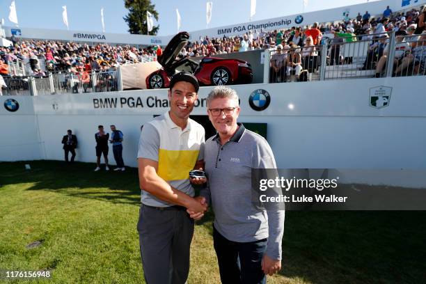 Ross Fisher of England receives the keys to the BMW i8 Roadster, from Graeme Grieve, BMW Chief Executive Officer, following an albatross on the 18th...