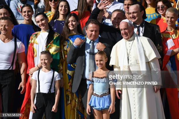 Pope Francis poses with members of a circus taking part in an Italian circus festival, during the weekly general audience on October 16, 2019 at St....