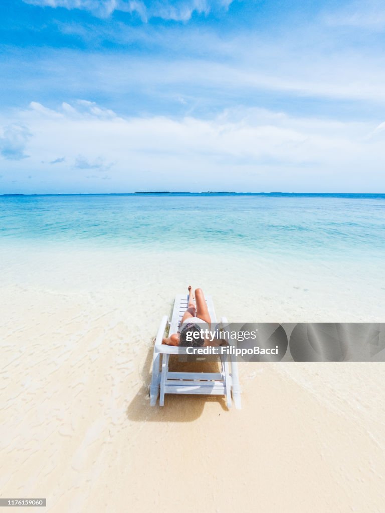 Young adult woman sunbathing on the beach - Maldives - Dharavandhoo Island