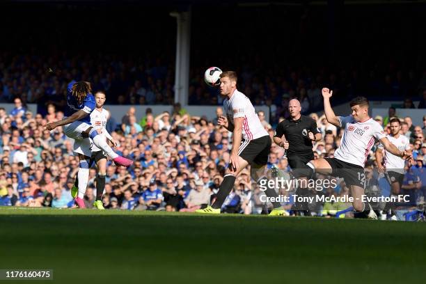 Moise Kean of Everton has a shot blocked by the head of Jack O'Connell during the Premier League match between Everton and Sheffield United at...