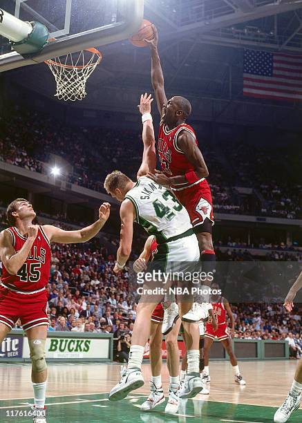 Michael Jordan of the Chicago Bulls dunks on Jack Sikma of the Milwaukee Bucks circa 1990 at The Bradley Center in Milwaukee, Wisconsin. NOTE TO...