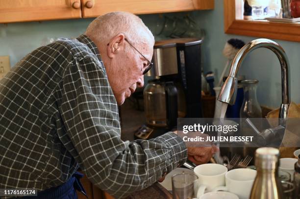 Curve Lake First Nation resident Murray Whetung touches water pouring out of his kitchen's sink inside of his house in Curve Lake, Canada, on October...