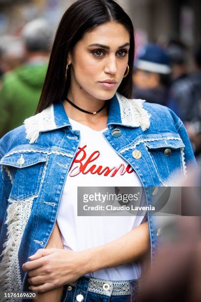 Cecilia Rodriguez, wearing a white Blumarine t-shirt and a denim jacket, is seen outside the Blumarine show during Milan Fashion Week Spring/Summer...