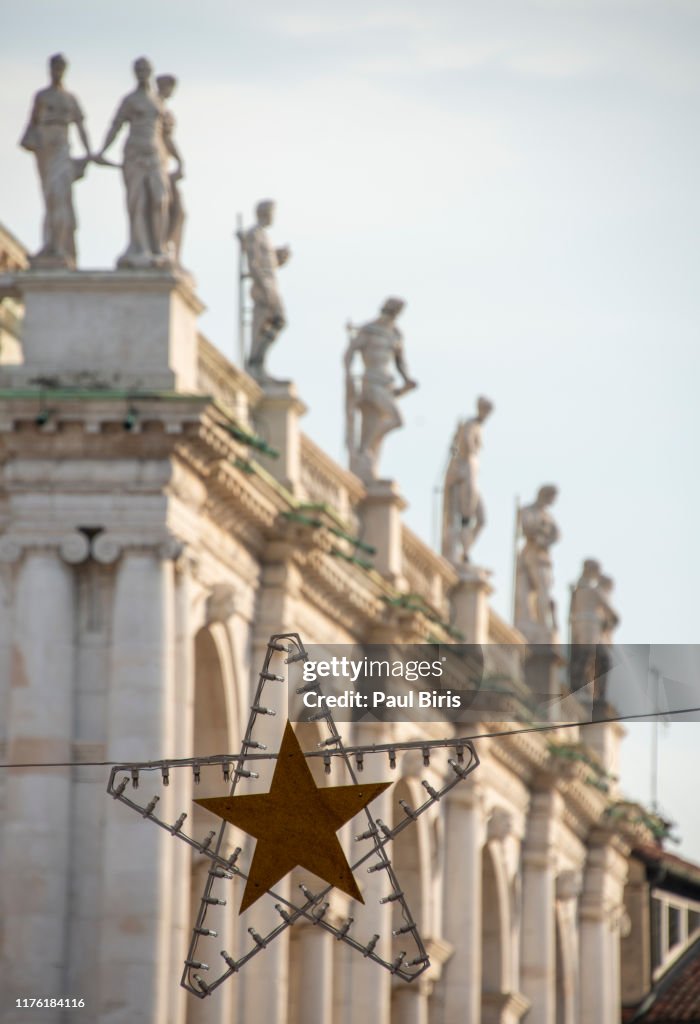 Small Christmas star in the center of Vicenza city, Basilica Palladiana in the background, Italy