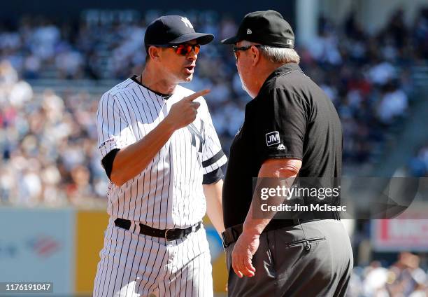 Manager Aaron Boone of the New York Yankees argues with umpire crew chief Joe West after he was ejected from a game against the Toronto Blue Jays...