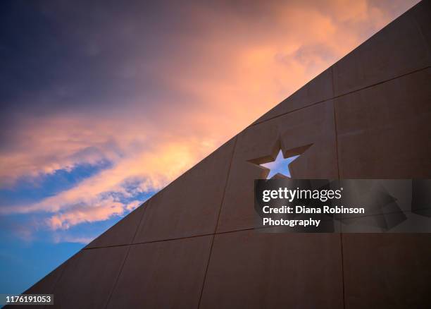 lone star and storm clouds over rest area in the palo duro canyon in the texas panhandle - stars v thunder stock pictures, royalty-free photos & images