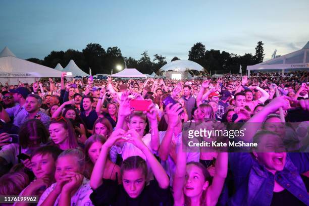 Fans look on as Rudimental perform on the Slingsby Show Stage following Day Three of the BMW PGA Championship at Wentworth Golf Club on September 21,...