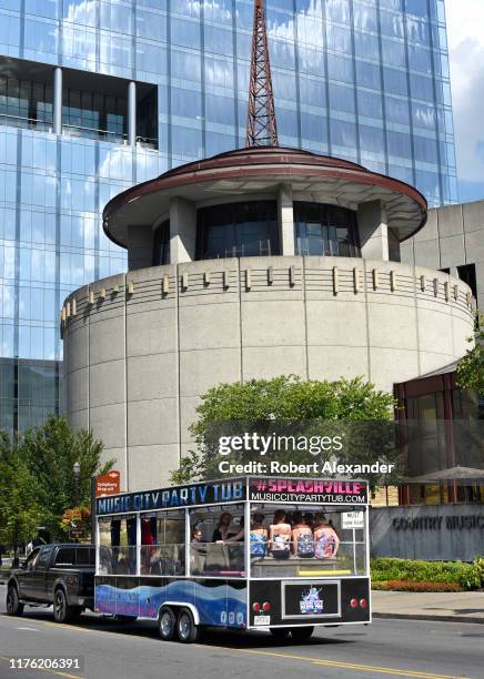 Music City Party Tub' bus filled with young women drives past the Country Music Hall of Fame and Museum in Nashville, Tennessee.