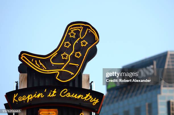 The Regions Bank building looms behind a neon sign over the entrance to a Nashville, Tennessee, bar and live country music venue in the city's Lower...