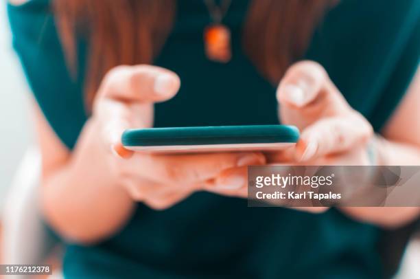 a young woman is using her smartphone - telegram messaging app stock-fotos und bilder