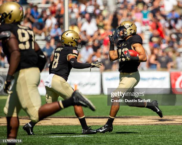 Elijah Riley of the Army Black Knights celebrates his interception with Javhari Bourdeau of the Army Black Knights during a game against the Morgan...