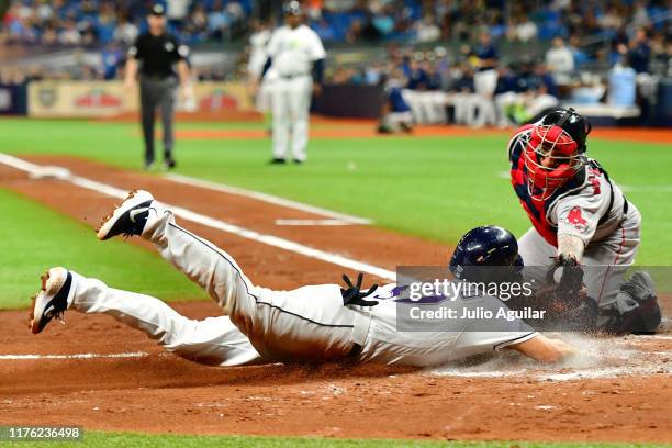 Christian Vazquez of the Boston Red Sox tags Travis d'Arnaud of the Tampa Bay Rays out at home plate during the third inning of a baseball game at...
