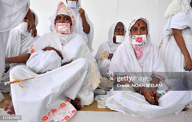Newly ordained Jain monks, Monica Tated and Manju Tated take part in a "Jain Bhagavati Deeksha Mahostav" ceremony in Hyderabad on May 15, 2010. As...