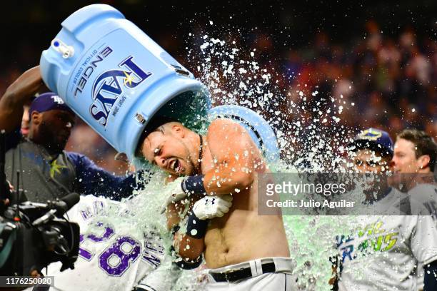 Nate Lowe of the Tampa Bay Rays gets a water cooler bath after a 2-run walk-off against the Boston Red Sox in the eleventh inning of a baseball game...